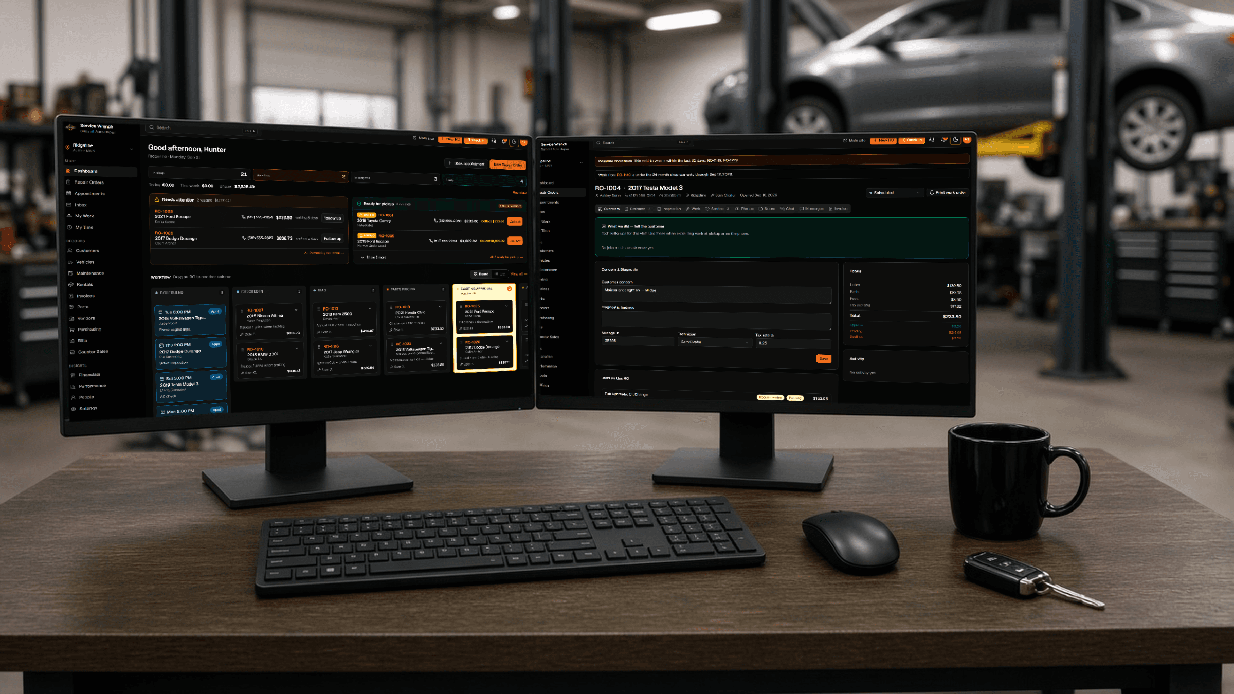 Service Wrench dashboard and repair order on dual monitors at the shop desk